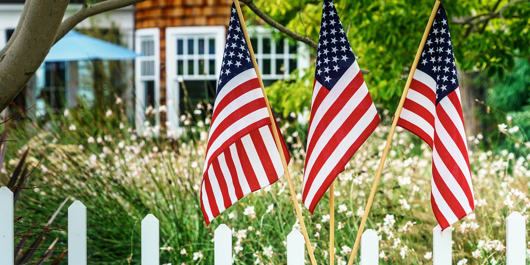 American flags hanging outside of home.