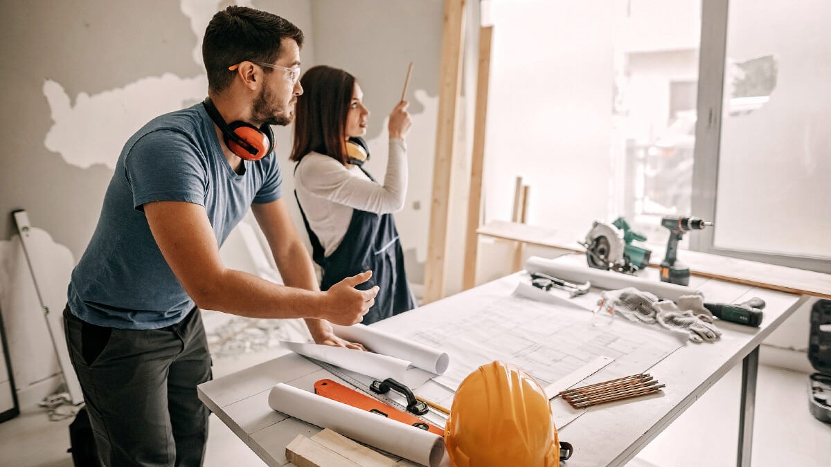 Couple having discussion while doing large scale home renovations.