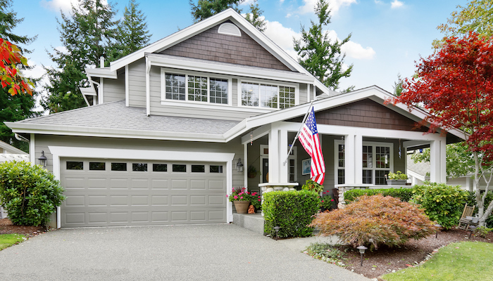 A suburban home with an american flag out front.